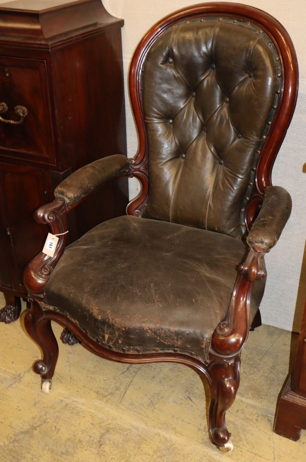 A Victorian black leather upholstered armchair, c.1860